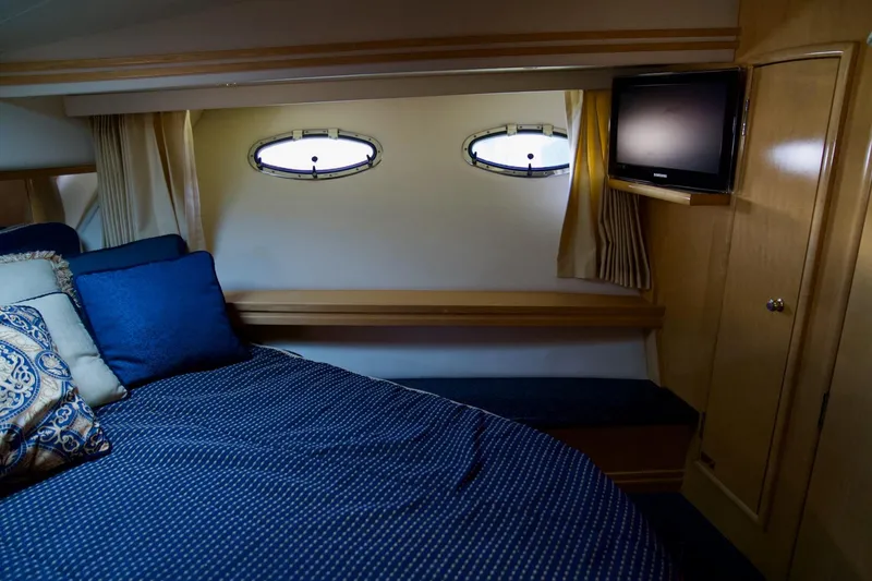 Slide: The Image of Cozy bedroom in 2000 Carver 506 Motor Yacht with portholes and TV. - 47