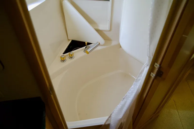 Slide: The Image of Bathtub in 2000 Carver 506 Motor Yacht, featuring compact design and chrome fixtures. - 56