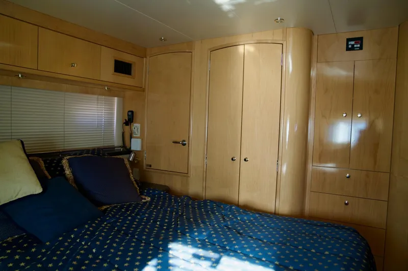 Slide: The Image of Luxurious bedroom interior of 2000 Carver 506 Motor Yacht with wood cabinetry and cozy bedding. - 61