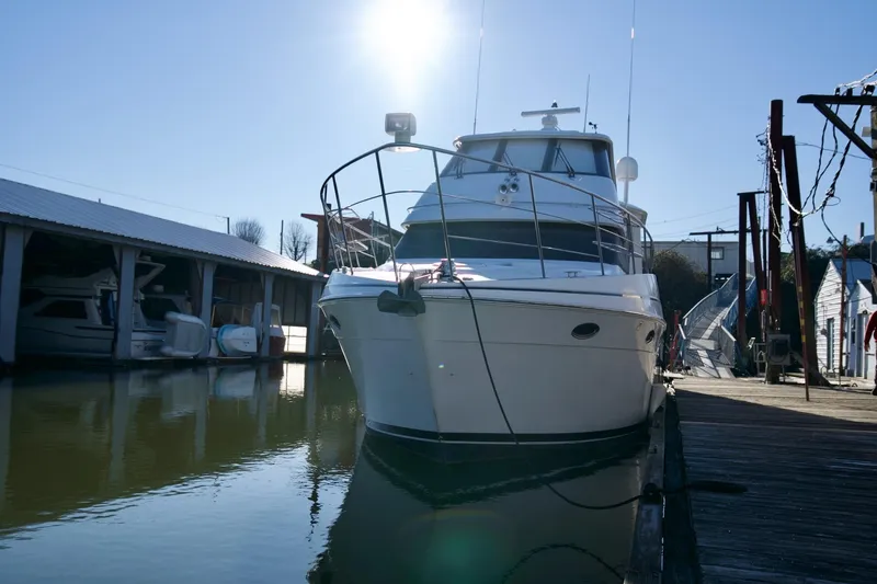 Slide: The Image of 2000 Carver 506 Motor Yacht docked in sunny marina setting. - 7