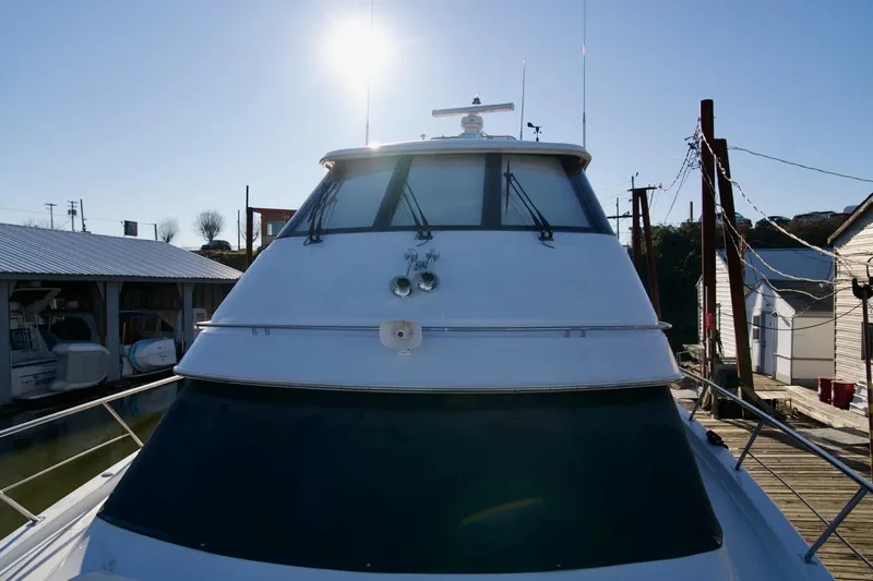 Slide: The Image of Front view of a 2000 Carver 506 Motor Yacht docked under a clear sky. - 13