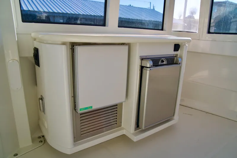 Slide: The Image of 2000 Carver 506 Motor Yacht interior with built-in mini fridge and storage unit. - 17