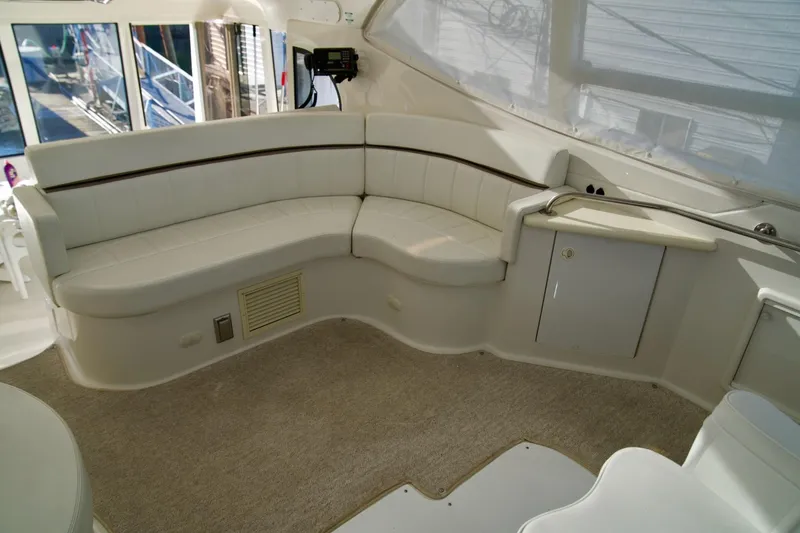 Slide: The Image of Interior of 2000 Carver 506 Motor Yacht with white seating and carpeted floor. - 19