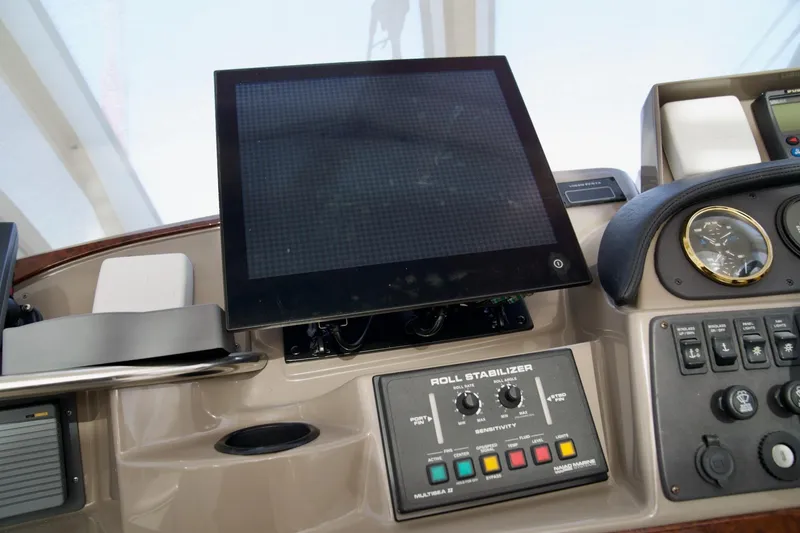 Slide: The Image of Control panel of a 2000 Carver 506 Motor Yacht with navigation and stabilizer systems. - 23