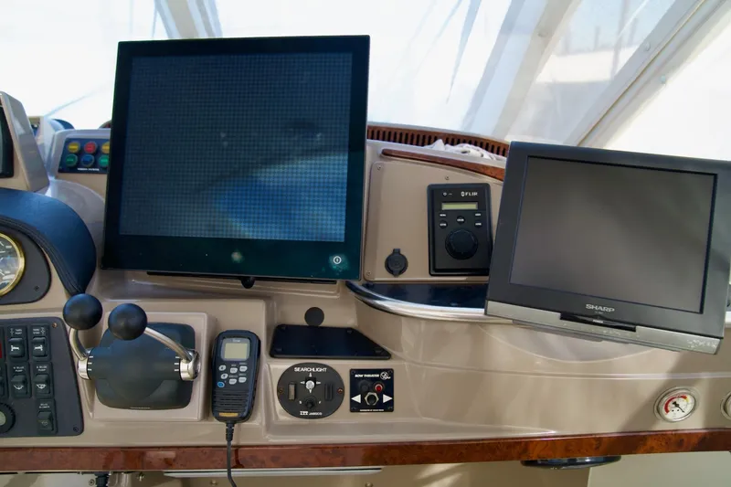 Slide: The Image of Control panel of a 2000 Carver 506 Motor Yacht with navigation screens and controls. - 24