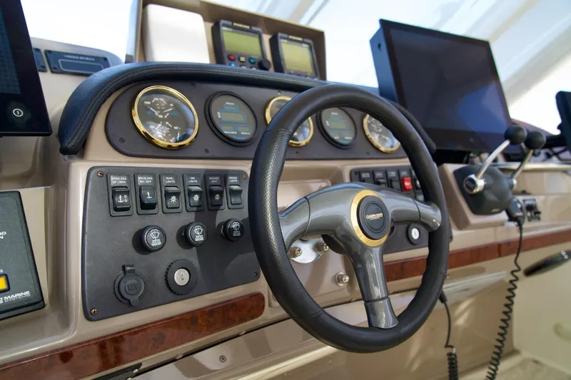 Slide: The Image of Steering console of a 2000 Carver 506 Motor Yacht with gauges and controls. - 25