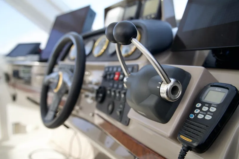 Slide: The Image of Control panel of a 2000 Carver 506 Motor Yacht with steering wheel and communication device. - 26