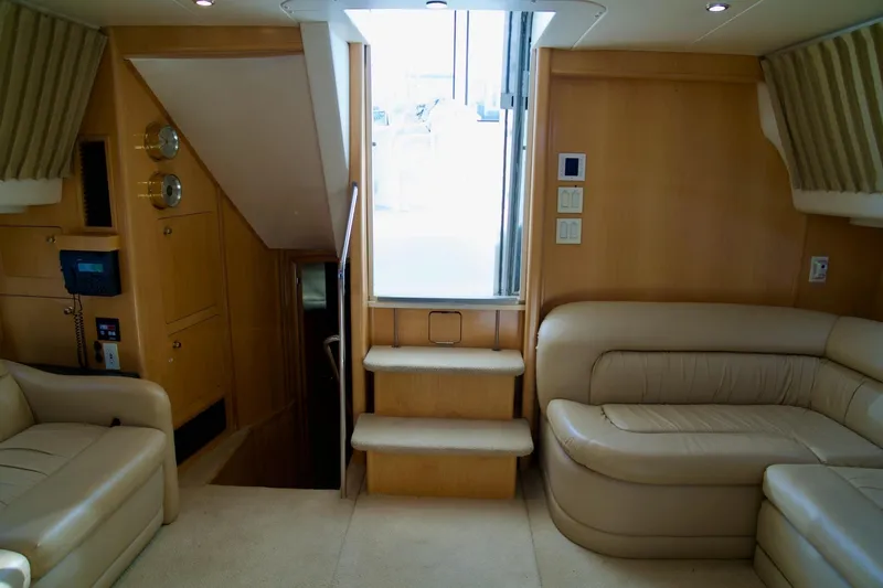 Slide: The Image of Interior of 2000 Carver 506 Motor Yacht with beige leather seating and wooden accents. - 37
