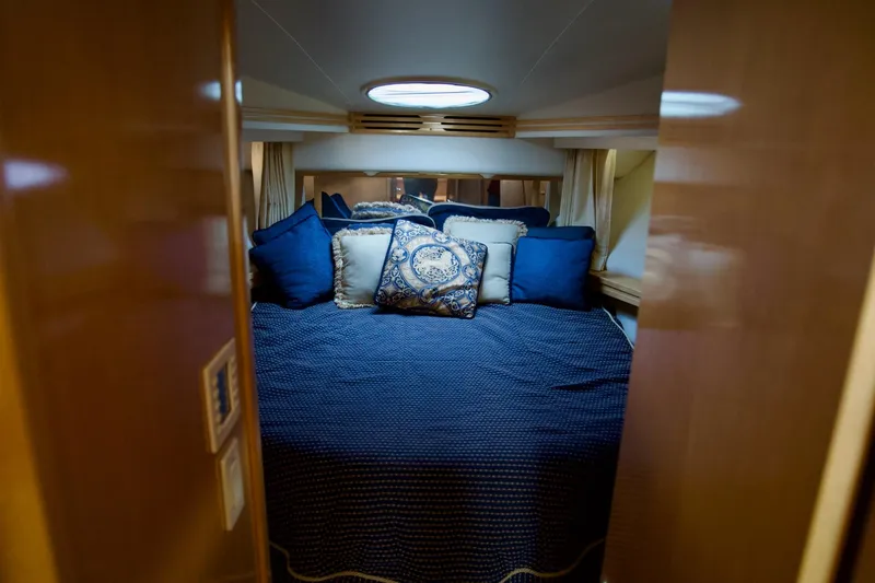 Slide: The Image of Luxurious bedroom in 2000 Carver 506 Motor Yacht with elegant blue bedding. - 42