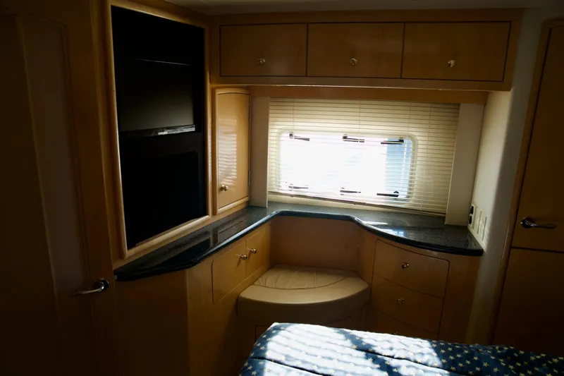 Slide: The Image of Luxurious interior of 2000 Carver 506 Motor Yacht with elegant wood cabinetry and window blinds. - 58