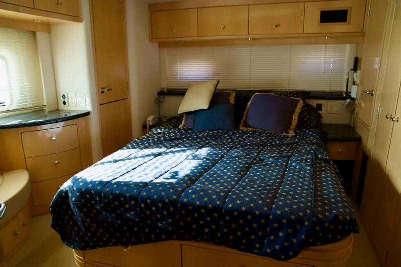 Slide: The Image of Luxurious bedroom interior of 2000 Carver 506 Motor Yacht with star-patterned bedding. - 60