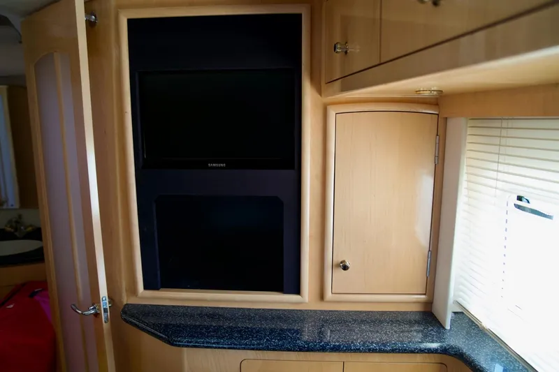Slide: The Image of Interior of 2000 Carver 506 Motor Yacht with TV and wooden cabinetry. - 63