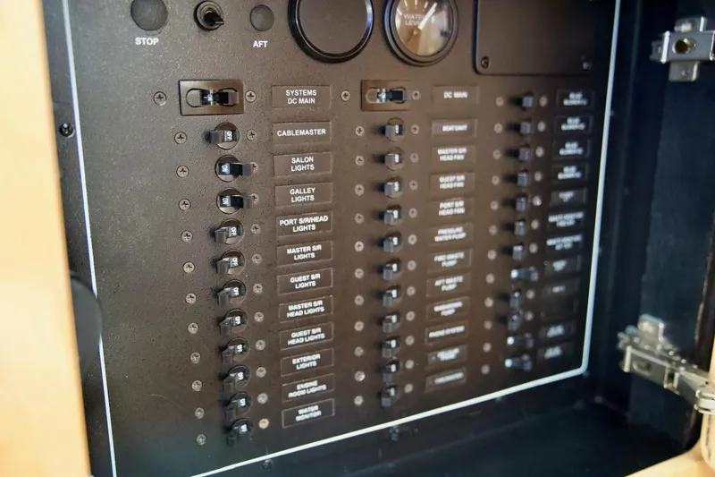 Slide: The Image of Electrical panel of a 2000 Carver 506 Motor Yacht with labeled switches and gauges. - 65