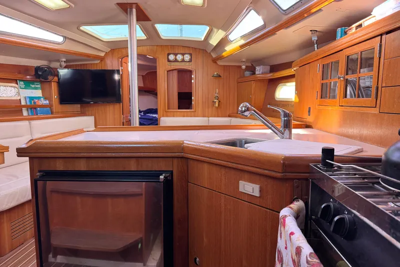Slide: The Image of Interior of a 2005 Hunter 36 sailboat with wood finish and modern amenities. - 10