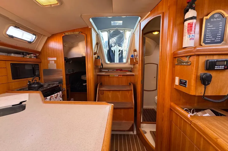 Slide: The Image of Interior of a 2005 Hunter 36 sailboat with wooden cabinetry and modern amenities. - 13