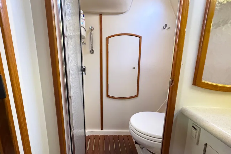 Slide: The Image of Compact bathroom in a 2005 Hunter 36 yacht, featuring a shower and toilet. - 17