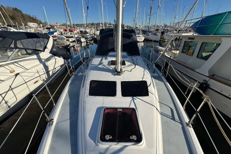 Slide: The Image of 2005 Hunter 36 sailboat docked in a marina, surrounded by other boats. - 20