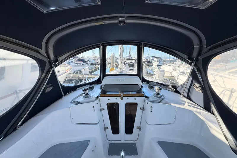 Slide: The Image of Interior view of a 2005 Hunter 36 sailboat cockpit with marina background. - 22