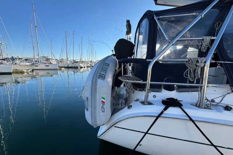 Slide: The Image of 2005 Hunter 36 sailboat docked in marina with inflatable dinghy attached. - 26