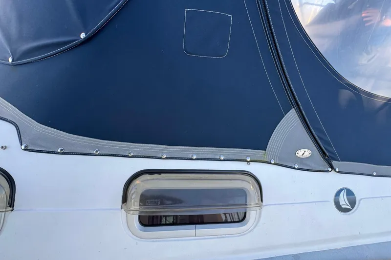 Slide: The Image of Close-up of a 2005 Hunter 36 sailboat's exterior with blue canvas and window. - 27