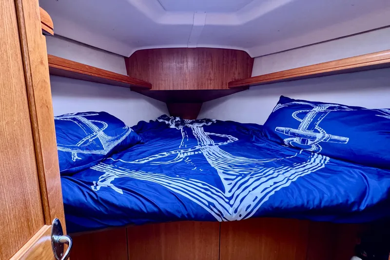 Slide: The Image of Cozy cabin interior of 2005 Hunter 36 sailboat with nautical-themed bedding. - 3
