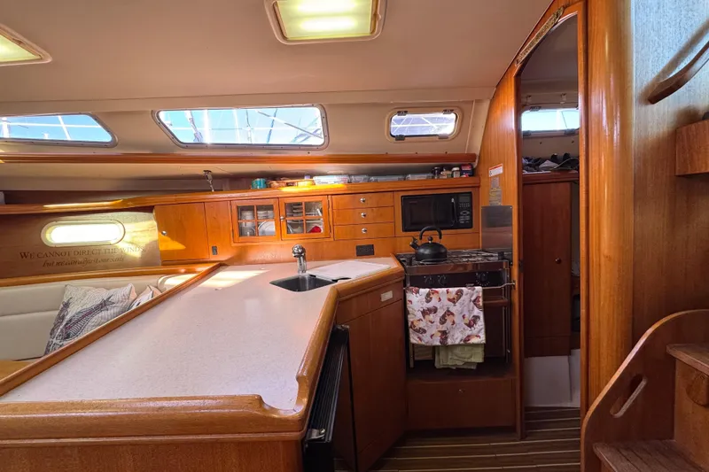 Slide: The Image of Interior of 2005 Hunter 36 sailboat with kitchen and seating area. - 8