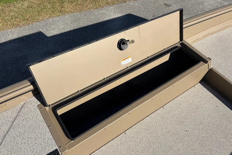 Slide: The Image of Open storage compartment on 2026 SeaArk DXS 1652 DKLD boat, beige interior. - 11