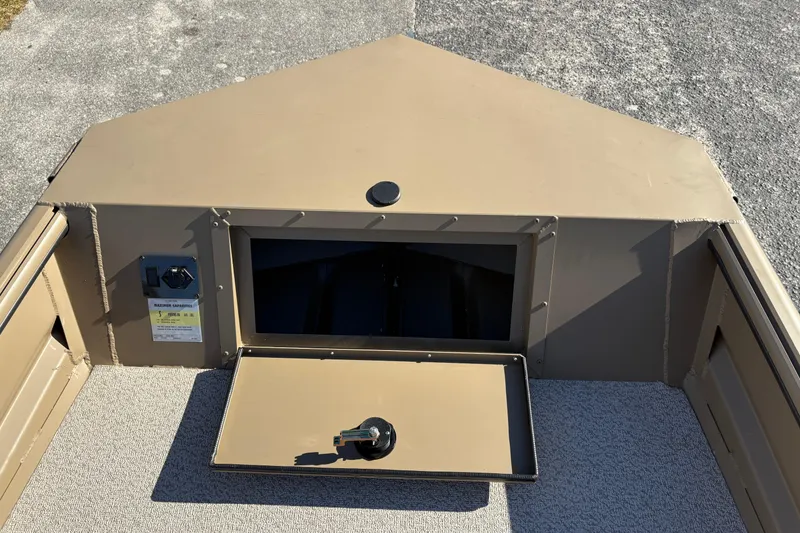 Slide: The Image of 2026 SeaArk DXS 1652 DKLD boat interior with storage compartment open. - 12