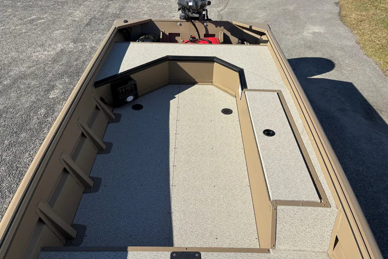 Slide: The Image of 2026 SeaArk DXS 1652 DKLD boat interior with storage compartments and control panel. - 13