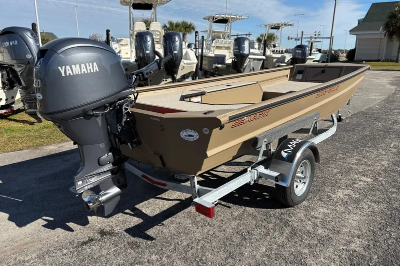 Slide: The Image of 2026 SeaArk DXS 1652 DKLD boat with Yamaha engine on trailer, parked outdoors. - 4