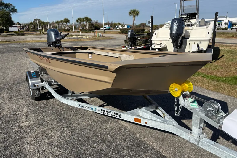 Slide: The Image of 2026 SeaArk DXS 1652 DKLD boat on trailer, parked outdoors. - 6