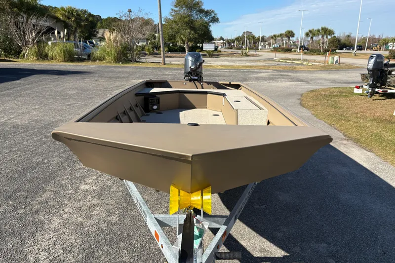 Slide: The Image of 2026 SeaArk DXS 1652 DKLD boat on trailer, parked outdoors, sunny day. - 7