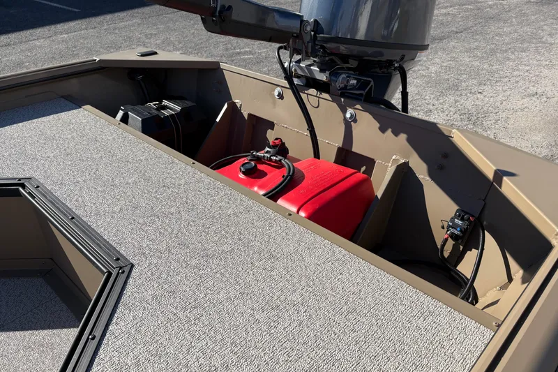 Slide: The Image of 2026 SeaArk DXS 1652 DKLD boat interior with motor and fuel tank. - 9