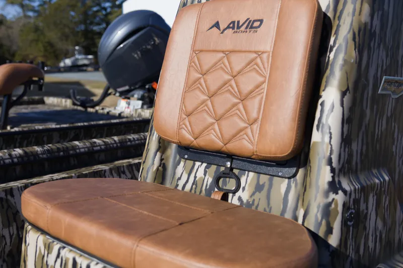 Slide: The Image of Avid 20 Rogue CC 2026 boat seat with camo design and leather upholstery. - 10