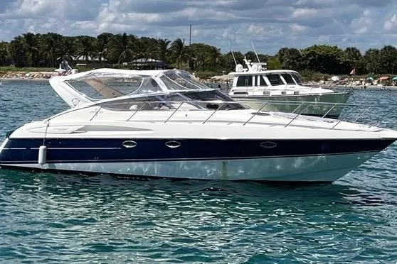 The Image of 2003 Cranchi Endurance 39 yacht on clear blue water, with scenic background. - 0