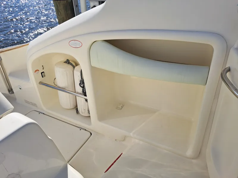 Slide: The Image of 2003 Cranchi Endurance 39 cockpit with white seating and waterfront view. - 12