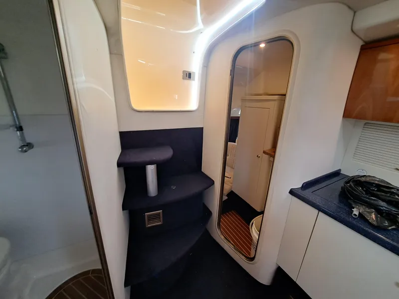 Slide: The Image of 2003 Cranchi Endurance 39 yacht interior with white seating and round table. - 17