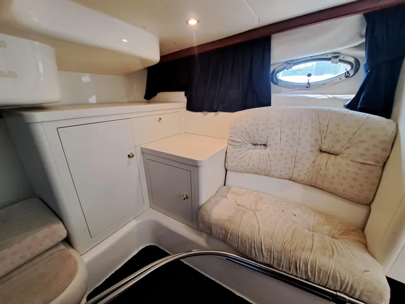 Slide: The Image of Interior cabin of 2003 Cranchi Endurance 39 with cushioned seating and storage cabinets. - 28