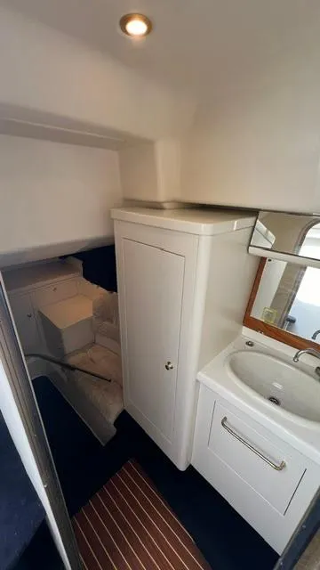 Slide: The Image of 2003 Cranchi Endurance 39 interior cabin with sink and storage. - 29