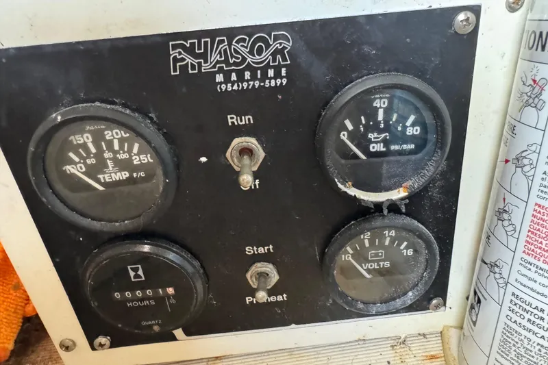 Slide: The Image of Control panel of a 2003 Cranchi Endurance 39 boat with gauges and switches. - 33