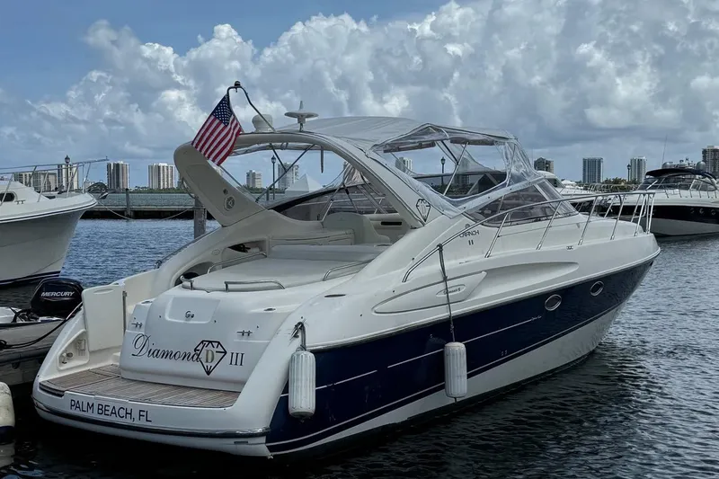 Slide: The Image of 2003 Cranchi Endurance 39 yacht docked at marina under cloudy sky. - 4