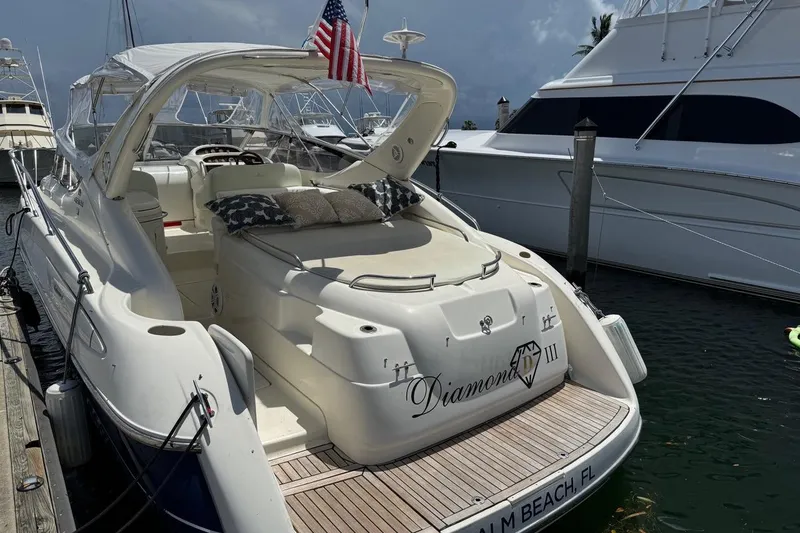 Slide: The Image of 2003 Cranchi Endurance 39 yacht docked, featuring elegant design and American flag. - 6