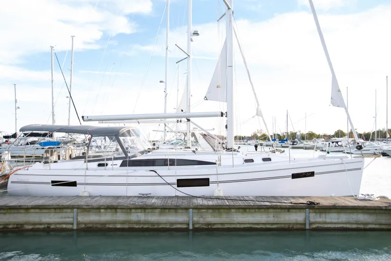 Slide: The Image of 2019 Catalina 425 sailboat docked at marina, sunlit with covered cockpit. - 1