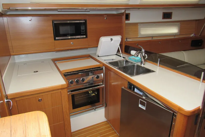 Slide: The Image of 2019 Catalina 425 yacht kitchen with modern appliances and wooden cabinetry. - 21