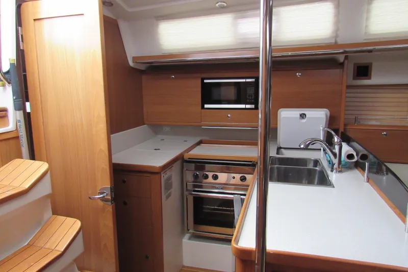 Slide: The Image of Modern kitchen interior of 2019 Catalina 425 yacht with wood cabinetry and stainless steel appliances. - 22