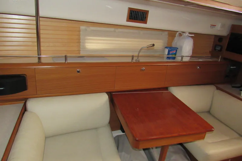 Slide: The Image of Interior of 2019 Catalina 425 yacht with wooden cabinetry and cozy seating area. - 30