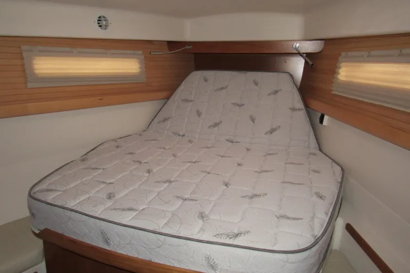 Slide: The Image of 2019 Catalina 425 cabin with comfortable mattress and wooden accents. - 34