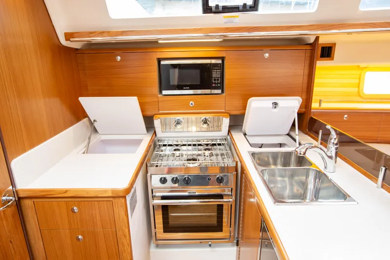 Slide: The Image of Modern kitchen in 2019 Catalina 425 yacht with stove, microwave, and dual sinks. - 44