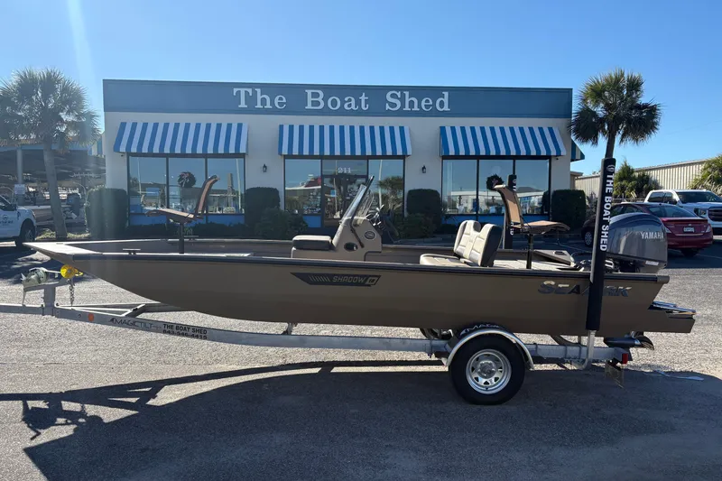 The Image of 2026 SeaArk Shadow 18 boat on trailer outside The Boat Shed dealership. - 1