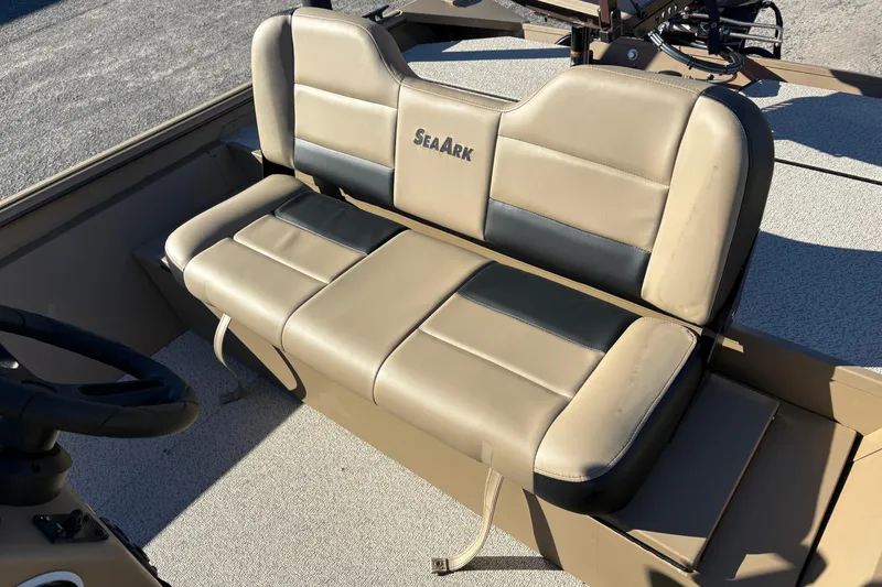 Slide: The Image of 2026 SeaArk Shadow 18 boat seat, beige and black upholstery, outdoor setting. - 12